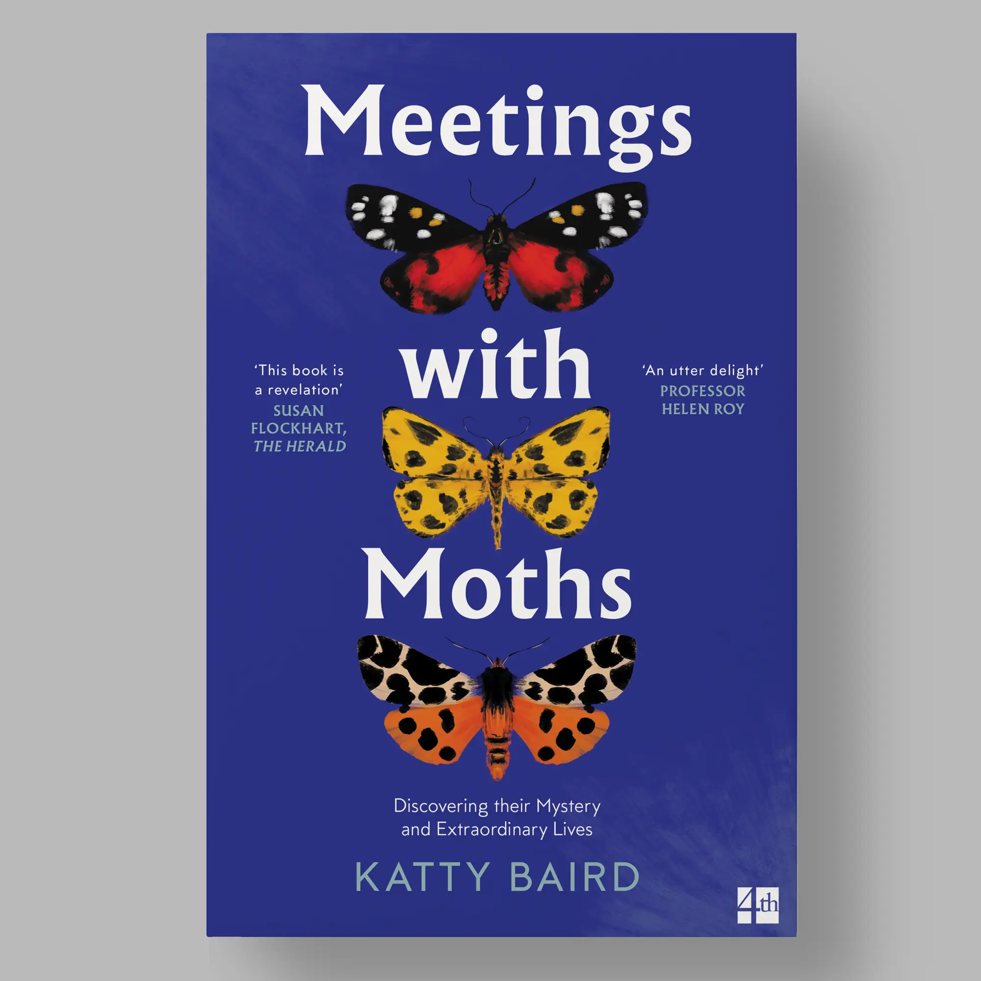 A blue book cover featuring three moths in vibrant colors: one in red and black, another in yellow with black spots, and a third in orange and black. The title, 'Meetings with Moths,' is written in large white text, with the subtitle, 'Discovering their Mystery and Extraordinary Lives,' appearing below.